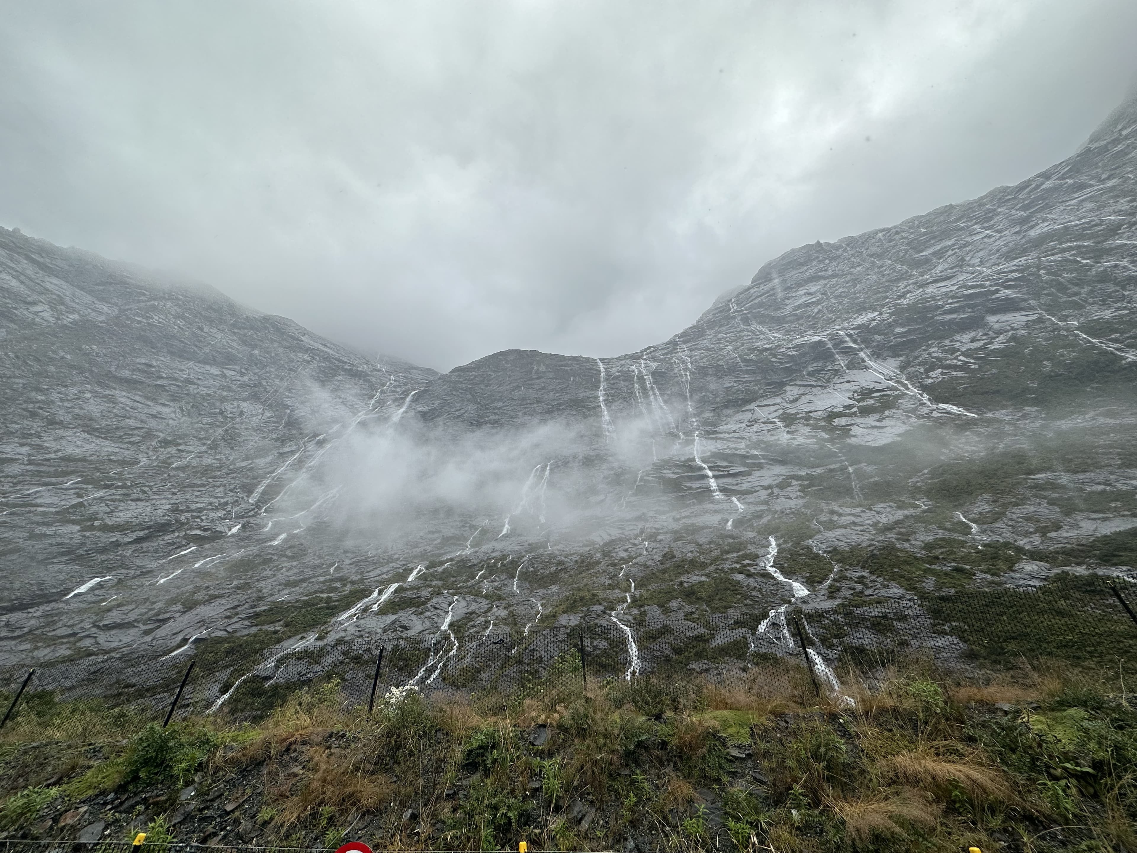 Rain-fed waterfalls streaming down a steep mountainside