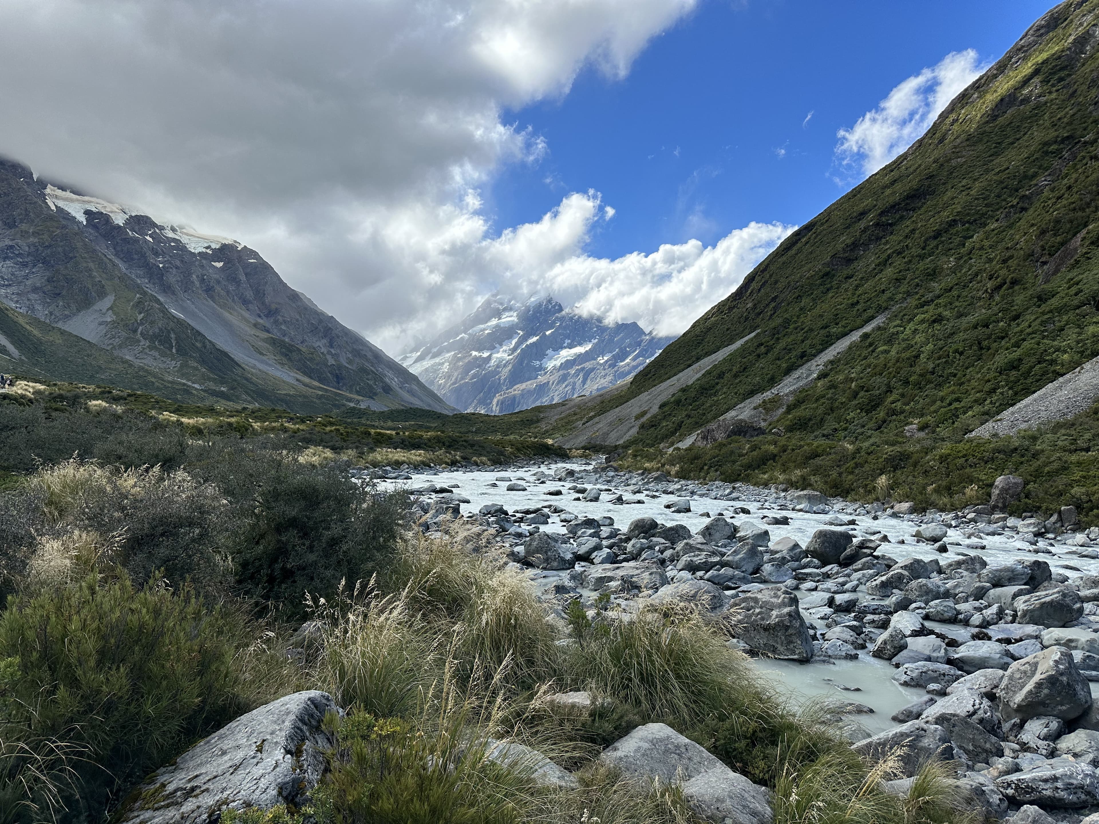 Glacial river valley leading toward a snow-capped peak