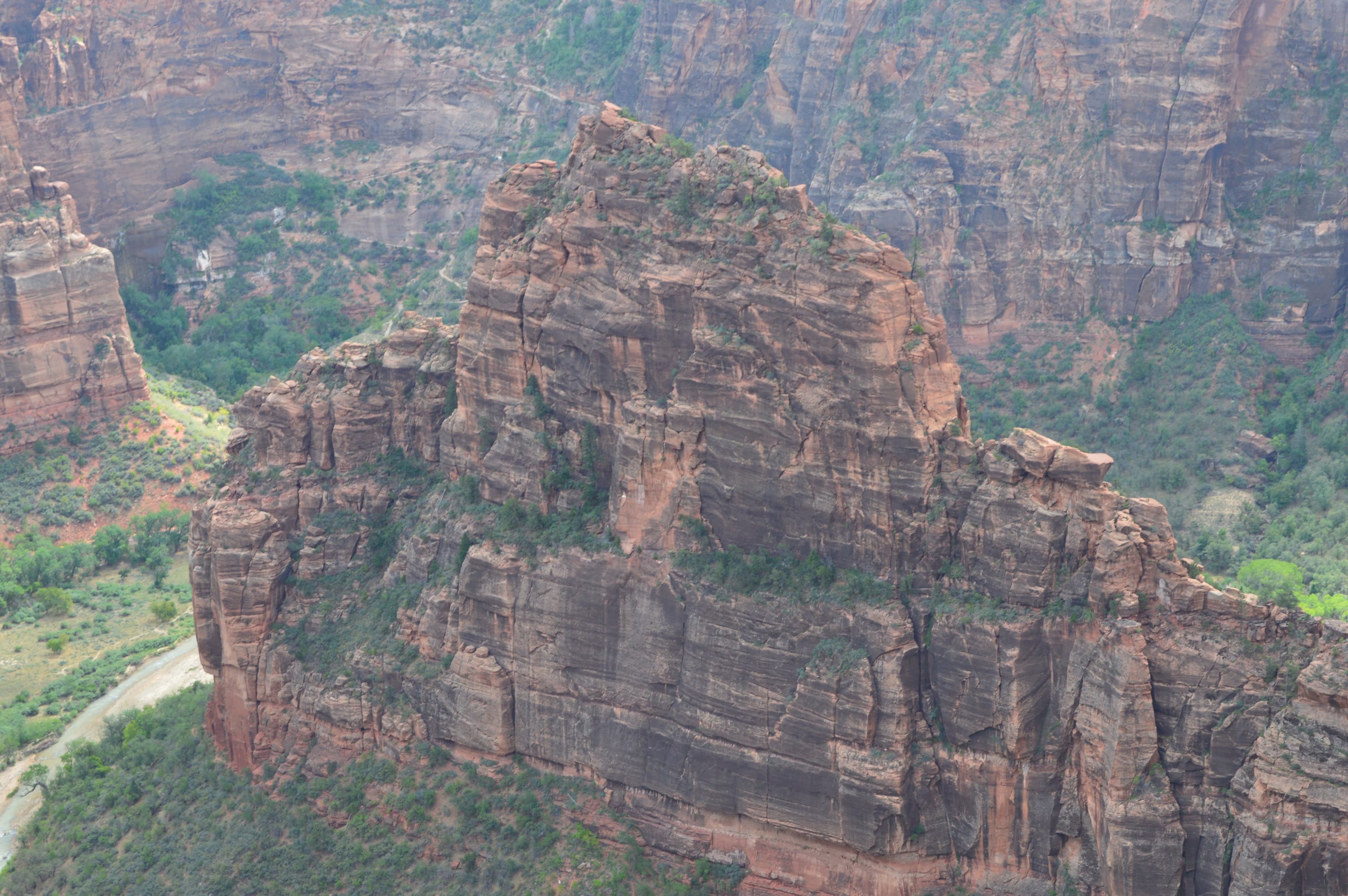 Towering red rock formations rising above desert terrain
